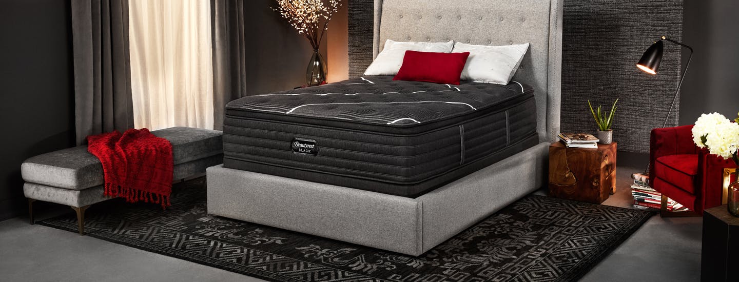 Beautyrest Black mattress in a dark room with red accents.
